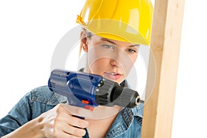 Construction Worker Using Cordless Drill On Wooden Plank