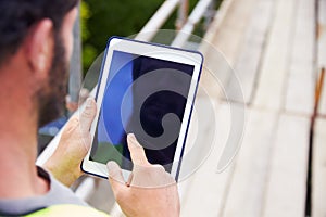 Construction Worker Using Digital Tablet On Building Site