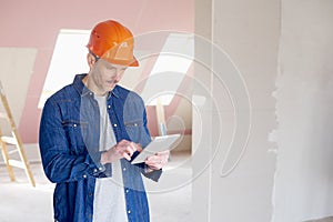 Construction worker using digital tablet while working