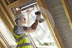 Construction Worker Using Drill To Install Window photo