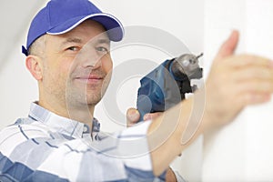 construction worker using electric drill on building site