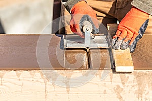 Construction Worker Using Hand Groover On Wet Cement Forming Coping Around New Pool