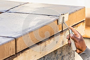 Construction Worker Using Hand Groover On Wet Cement Forming Coping Around New Pool