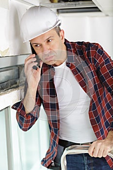 Construction worker using mobile phone