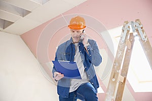 Construction worker using his mobile phone