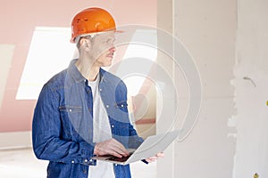 Construction worker using laptop