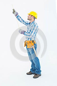 Construction worker using measure tape