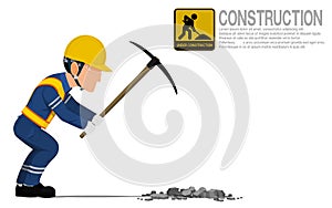 A construction worker is using pickaxe for digging hole on the ground