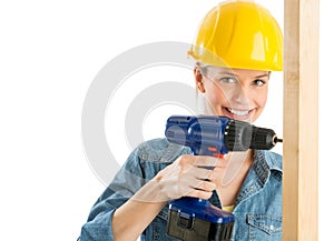 Construction Worker Using Power Drill On Wooden Plank