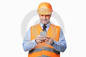 Construction Worker Using Smartphone Standing On White Studio Background
