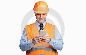 Construction Worker Using Smartphone Standing On White Studio Background