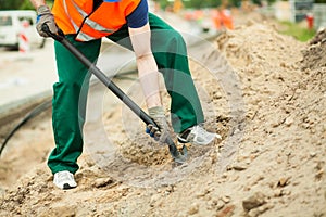 Construction worker using spade