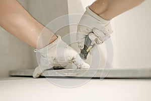 Construction worker using spirit level at home interior