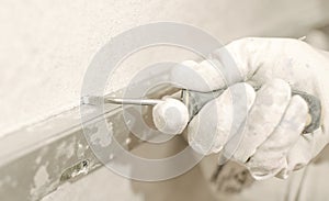 Construction worker using spirit level at home interior