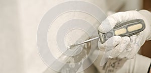 Construction worker using spirit level at home interior