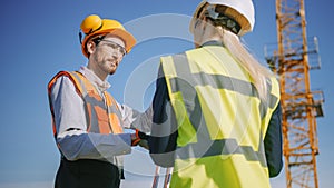 Construction Worker Using Theodolite Surveying Optical Instrument for Measuring Angles in Horizont