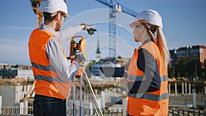 Construction Worker Using Theodolite Surveying Optical Instrument for Measuring Angles in Horizont