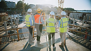 Construction Worker Using Theodolite Surveying Optical Instrument for Measuring Angles in Horizont