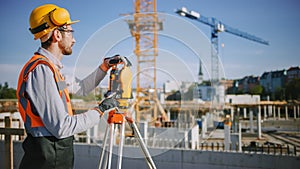 Construction Worker Using Theodolite Surveying Optical Instrument for Measuring Angles in Horizont