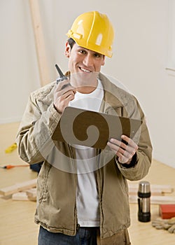 Construction worker using walkie talkie