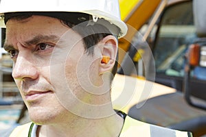 Construction Worker Wearing Protective Ear Plugs