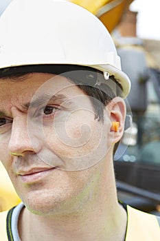 Construction Worker Wearing Protective Ear Plugs