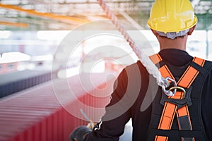 Construction worker wearing safety harness and safety line