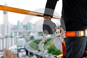 Construction worker wearing safety harness and safety line