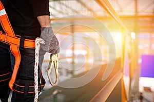 Construction worker wearing safety harness and safety line