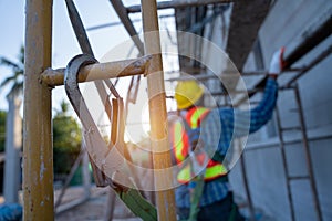 Construction worker wearing safety harness and safety line working at high place, Fall arrestor device for worker with hooks for