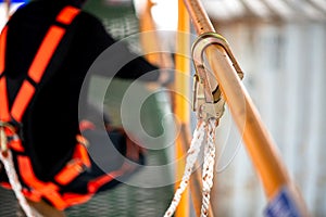 Construction worker wearing safety harness working at high place