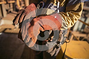 Construction worker wearing safety industry heavy duty reinforced quality leather gauntlet welding glove protection