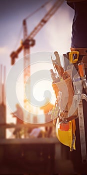 Construction worker wearing tool belt at building site