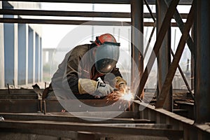 A Construction Worker Welding Reinforcements on a Steel Structure