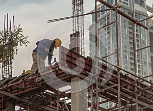 Construction Worker Welding soldering metal girders and Sparks