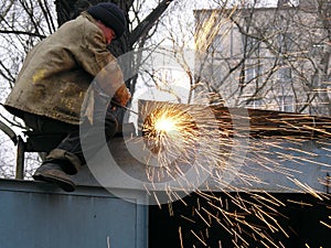 A construction worker welding steel