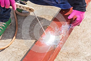 Construction worker welding steel for roof structure