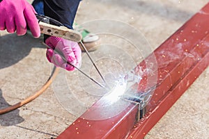 Construction worker welding steel for roof structure