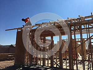 Construction worker working on the framing process for a new a house