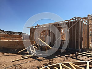 Construction worker working on the framing process for a new a house.