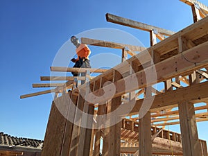 Construction worker working on the framing process for a new a house.
