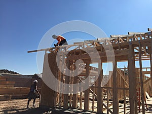 Construction worker working on the framing process for a new a house.