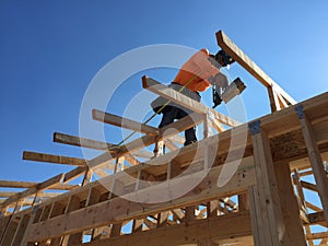 Construction worker working on the framing process for a new a house.