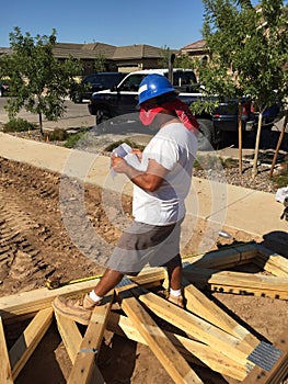 Construction worker working on the framing process for a new a house.