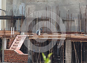 A construction worker working on the roof supported by bars