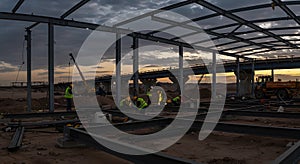 Sunset Construction Workers Building Steel Structure