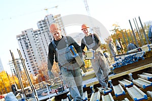 Construction workers at building area installing wormwork