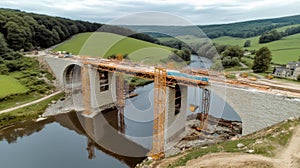 Construction workers building a bridge over river in countryside