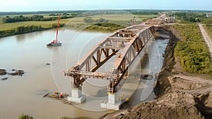 Construction workers building a bridge over wide river