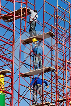 Construction workers building a new structure in city